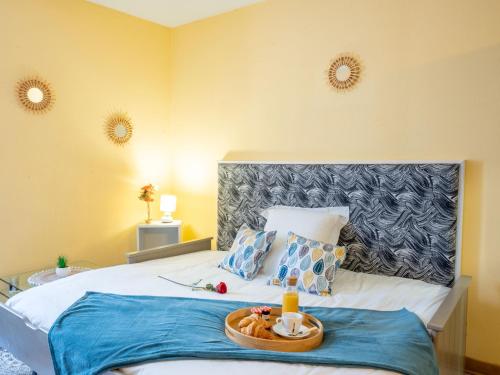 a bedroom with a bed with a tray of food on it at Studio Studio des Halles by Interhome in Pornic