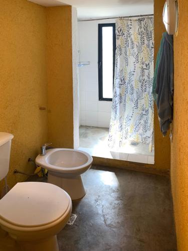 a bathroom with a toilet and a sink and a window at La Molicie, Achiras Arriba in San Javier