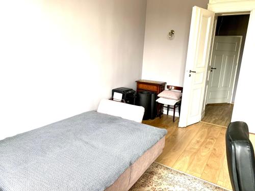 a bedroom with a bed and a desk and a chair at 1 Bedroom Lux Apartment Center Vincent in Wrocław