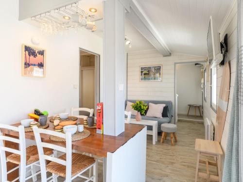 a kitchen and living room with a table and chairs at Apartment Bleuet by Interhome in Mimizan