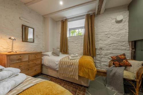 a bedroom with two beds and a window at The Garden Barn in Peterchurch