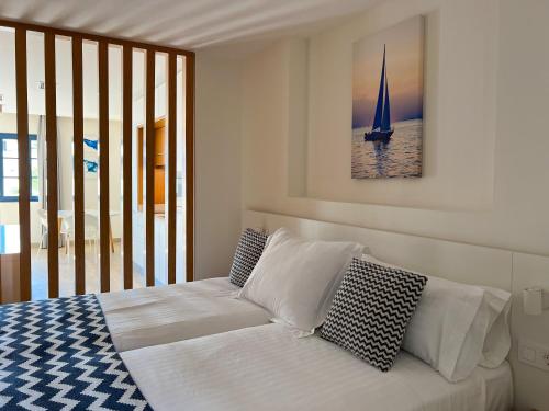 a bedroom with a bed with a sailboat on the wall at Hotel Cordial Marina Blanca in Playa Blanca