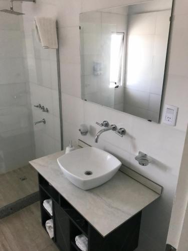 a bathroom with a white sink and a mirror at BLU APARTMENTS in San Rafael