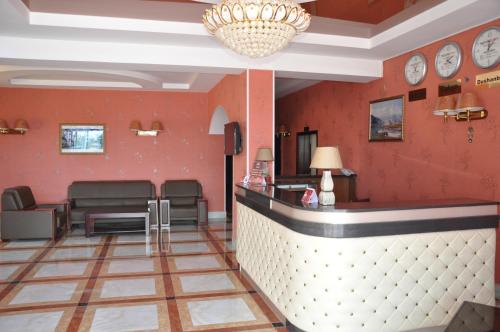a bar in a waiting room with clocks on the walls at Firuz Hotel in Khujand