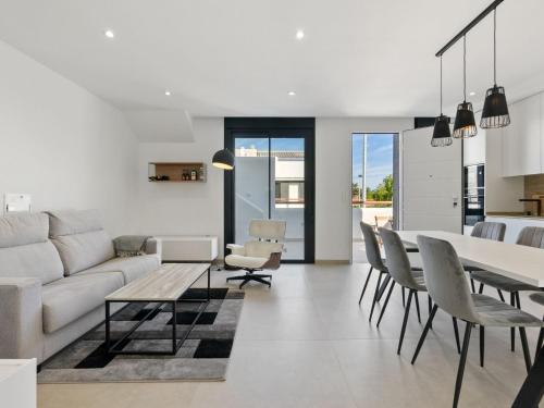 een woonkamer met een witte bank en een tafel bij Apartment Tropical Beach Penthouse by Interhome in Santiago de la Ribera