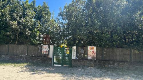 a fence with a gate with signs on it at Apartamentos ELROSAL2 in Cudillero