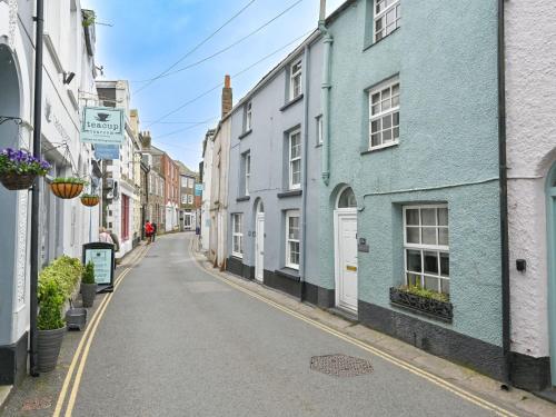 an empty street with blue and white houses at Holiday Home Mariners Rest by Interhome in Mevagissey