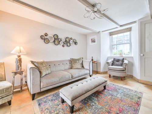 a living room with a couch and a chair at Holiday Home Mariners Rest by Interhome in Mevagissey