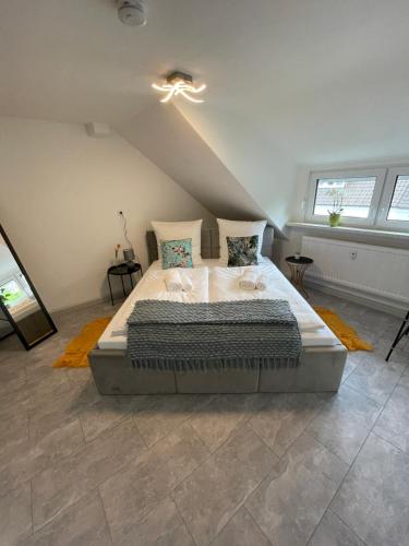 a bedroom with a large bed in a attic at WEN Königsberger,ruhige DG-Wohnung in Weiden,2 Schlafzimmer,Parkplatz, zentral! in Weiden