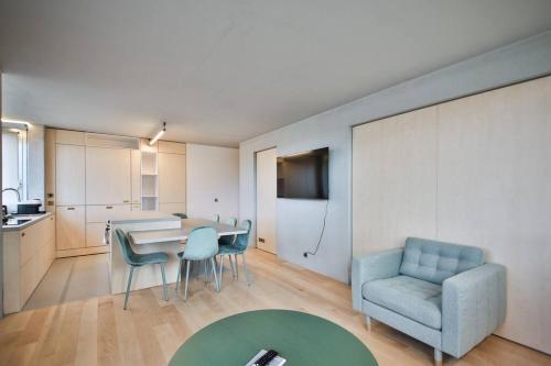 a living room with a table and a blue chair at Luxurious flat/3bedrooms/Amazing view/EffeilTower in Paris