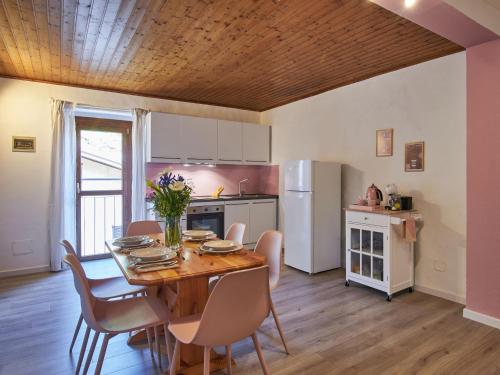 a kitchen and dining room with a table and chairs at Apartment Ca' Dolce Osteno by Interhome in Claino