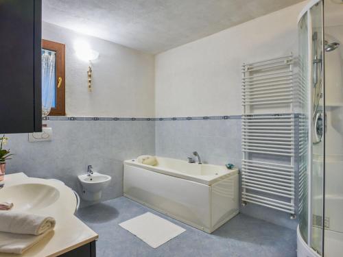 a bathroom with a tub and a toilet and a sink at Holiday Home Casa Grandola-Green Garden by Interhome in Naggio