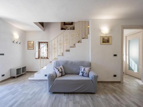 een woonkamer met een bank en een trap bij Holiday Home Raggio di Sole by Interhome in Pontestura