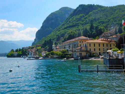 a body of water with buildings and a mountain at Holiday Home Casa Grandola-Green Garden by Interhome in Naggio