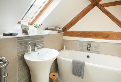 a bathroom with a sink and a bath tub at Unconformity Barn in Hope Bowdler