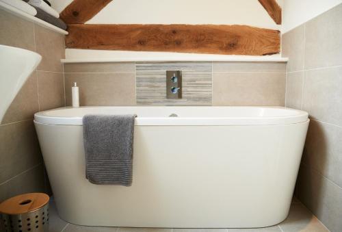 a bathroom with a toilet with a towel on it at Unconformity Barn in Hope Bowdler