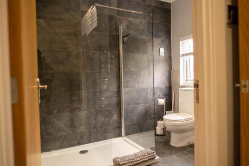 a bathroom with a shower and a tub and a toilet at Rose Cottage in Shrewsbury