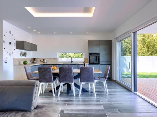 a kitchen and dining room with a table and chairs at Holiday Home Villa Dora by Interhome in Pula