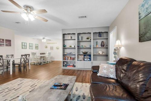 a living room with a couch and a table at Gulf Brz-Beaches-Dwntwn PNS-Pet Friendly-Canal in Gulf Breeze