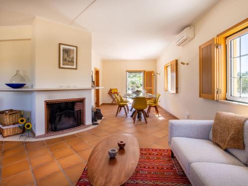 a living room with a couch and a fireplace at Holiday Home Vista Panorâmica- Herdade de Montalvo by Interhome in Alcácer do Sal