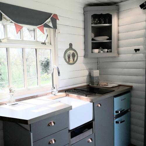a kitchen with a sink and a stove at The Shepherd's Hut in Sheriff Hutton