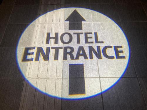 a sign for a hotel entrance on a floor at Henn na Hotel Fukuoka Hakata in Fukuoka