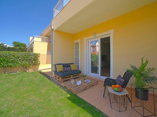 a patio with a couch and a table and chairs at Holiday Home Sunset Terrace by Interhome in Pêra