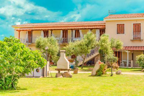 a house with a garden in front of it at Stella Marina Budoni in Budoni