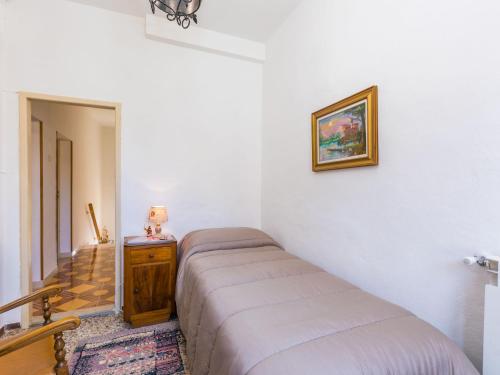 a bedroom with a bed and a dresser in a room at Holiday Home A casa di Gabri by Interhome in Montefollonico