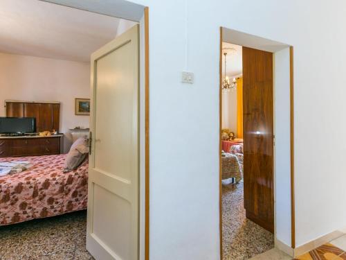 a bedroom with a door leading to a bed at Holiday Home A casa di Gabri by Interhome in Montefollonico