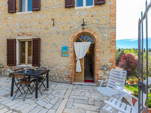 a patio with a table and chairs in front of a building at Holiday Home A casa di Gabri by Interhome in Montefollonico