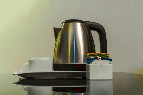 a tea kettle sitting on top of a table at Gis Select Banjara Hill in Hyderabad