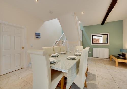 a dining room with a table and chairs at High Mill in Beadnell