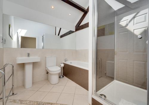 a bathroom with a toilet and a sink and a shower at High Mill in Beadnell