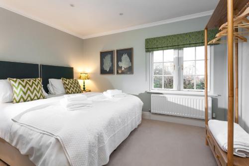 a bedroom with a large white bed and a window at East House in Pickmere