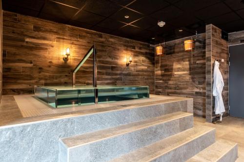 a lobby with a bench and a mirror at Pernilla Wiberg Hotel in Idre