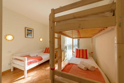 a bedroom with two bunk beds in a room at L'Hermitage, 4 appartements avec terrasse, vue lac, parking et PISCINE, LLA Selections by Location Lac Annecy in Talloires