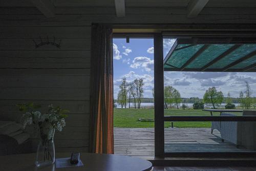 an open door to a porch with a view of a deck at Dvarčėnų dvaras in Dvarčėnai