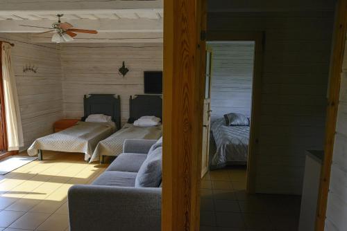 a living room with two beds and a couch at Dvarčėnų dvaras in Dvarčėnai