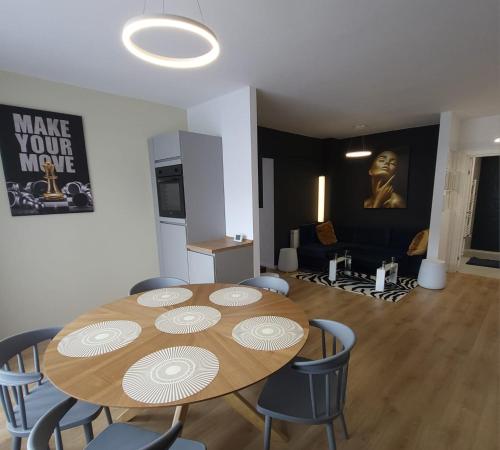 a dining room with a wooden table and chairs at David’s place in Floreşti