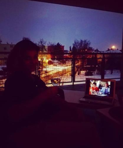 a person sitting in front of a laptop computer at Apartmán s terasou in Tábor