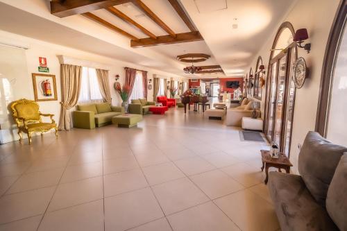 a large living room with couches and chairs at Paloma Blanca Boutique Hotel in Marbella
