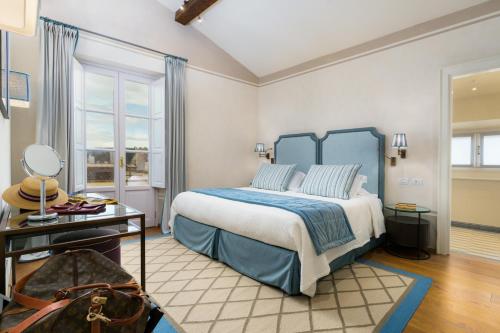 a bedroom with a bed with a blue headboard at Donna Lipsi - La Dimora degli Affreschi Florence in Florence