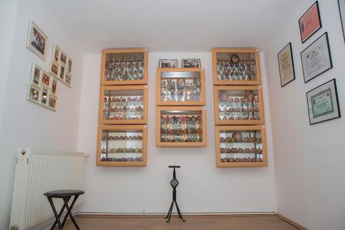 a white wall with many pictures on it at Fexada Home in Vama