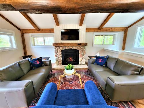 sala de estar con sofás y chimenea en Exclusive 2 Chalet Stay-HotTub-Fireplace-Beachside en Traverse City