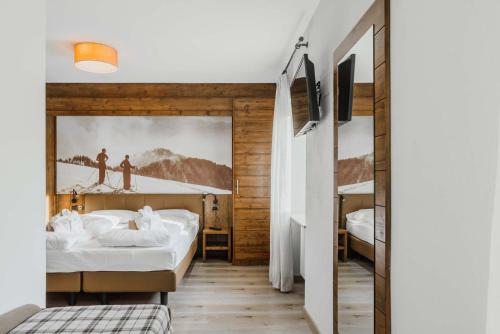 Letto o letti in una camera di Family Hotel Gran Baita