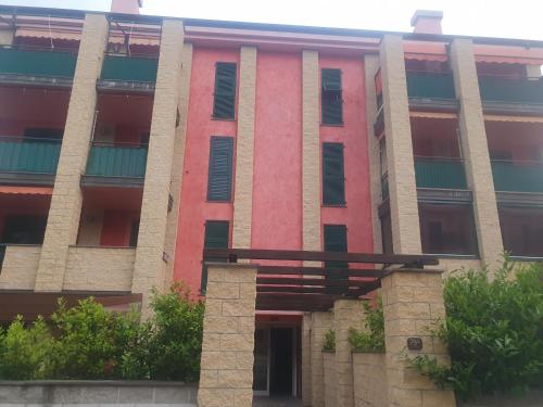 a red brick building with trees in front of it at Sestri DeLuxe Penthouse All Included in Sestri Levante