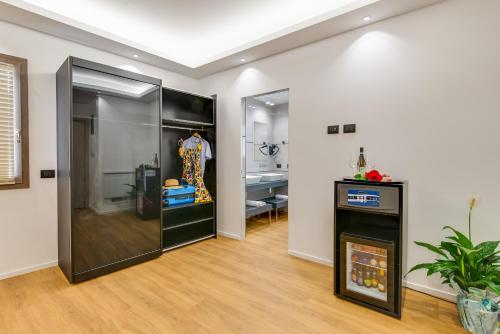a living room with black cabinets and wood floors at RoccaRegina Hotel in Sciacca