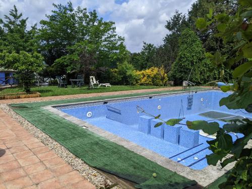 a swimming pool with a green lawn around it at Casa Rural Bilbao Caserio Gondra Alquiler Habitaciones in Mungia