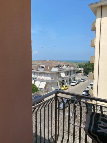 a balcony with a view of a street at Karpa House in Sottomarina